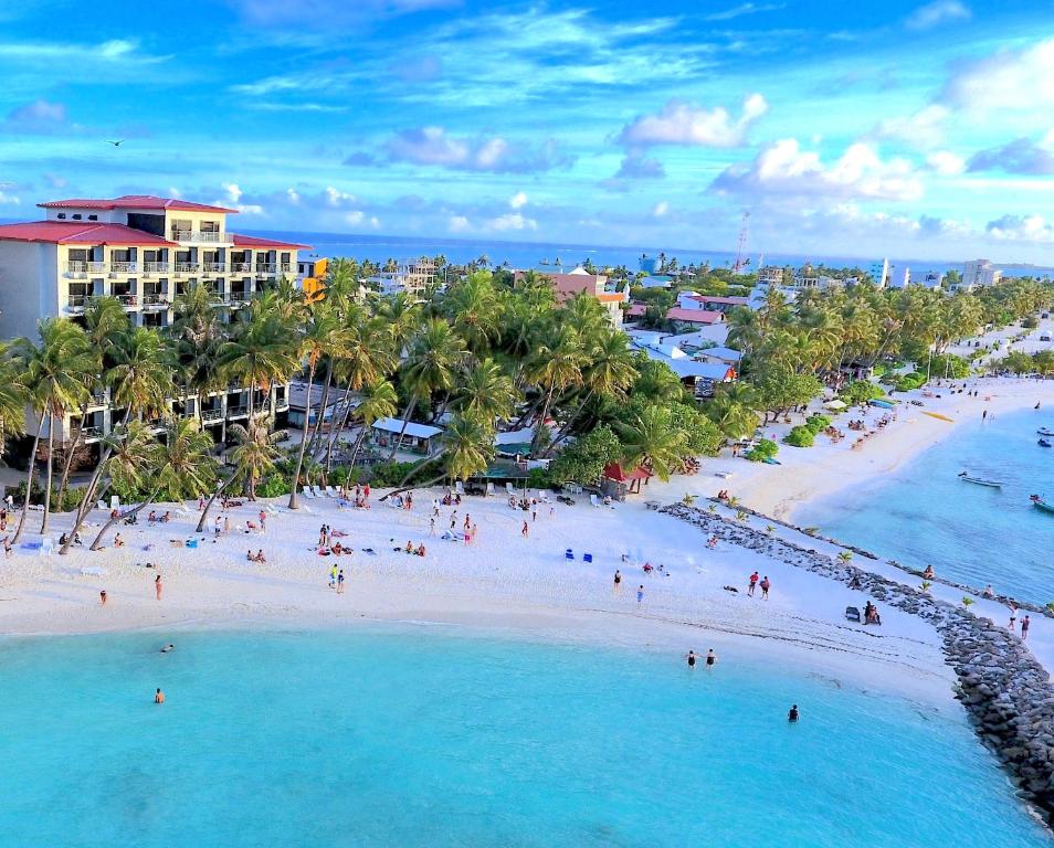 an aerial view of a beach with people in the water at Kaani Grand Seaview in Maafushi