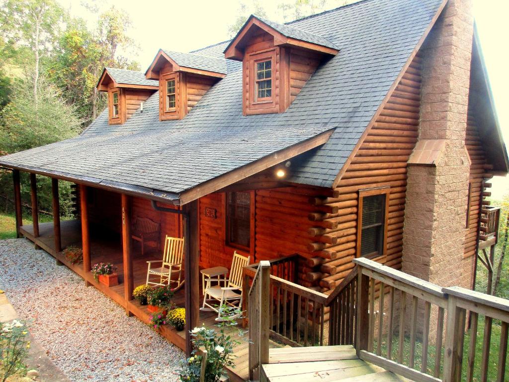 a log cabin with chairs and a porch at Alpine Log Cabin in Boone