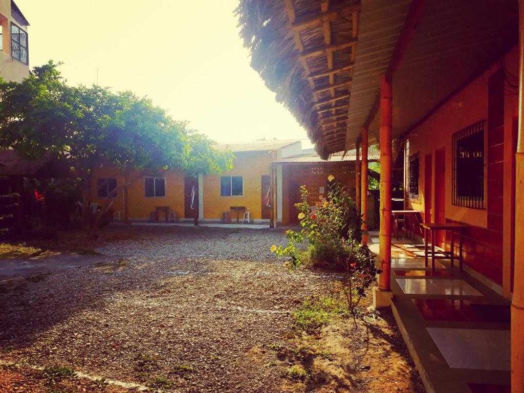 an outside view of a building with a yard at La Casa De Lili in Olón