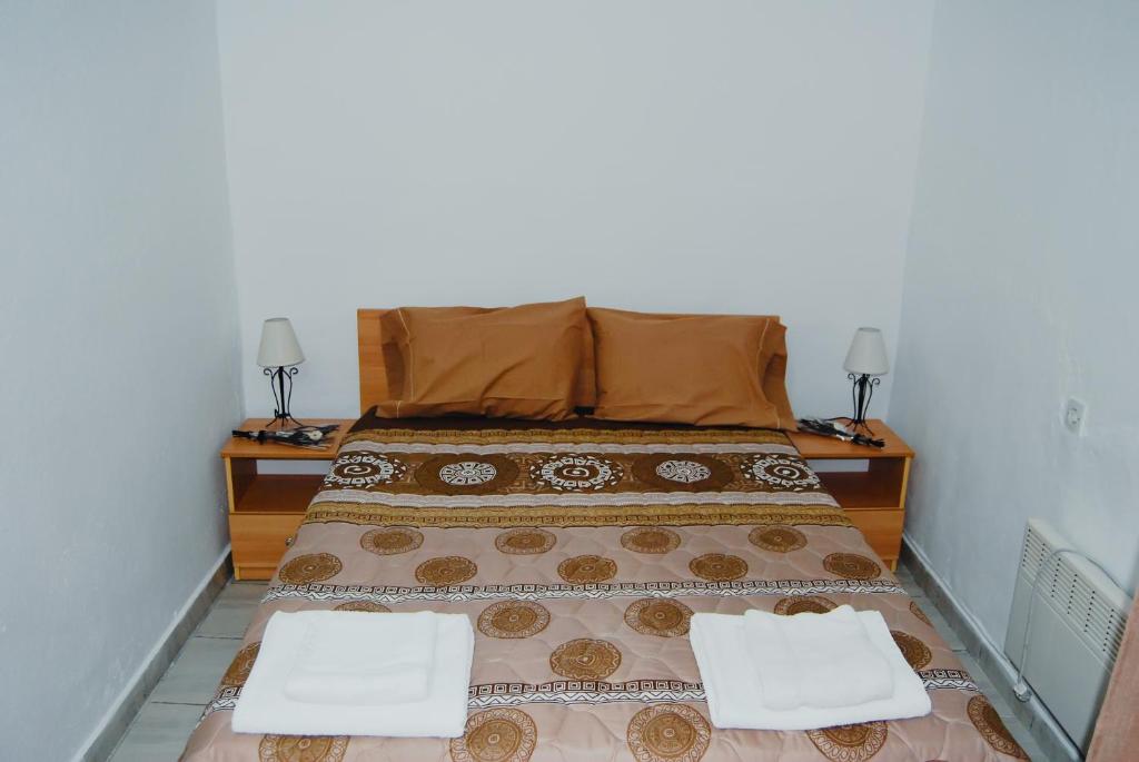a bedroom with a bed with two towels on it at Cosy Studio Down Town in Kavala