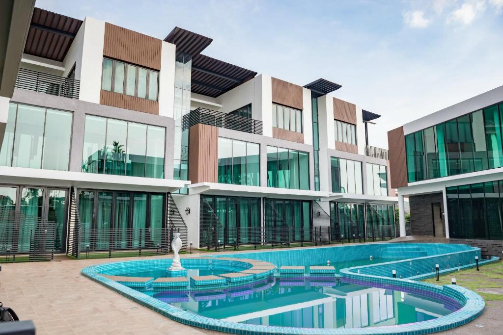 a building with a swimming pool in front of it at Hermitage Boutique House in Taiping