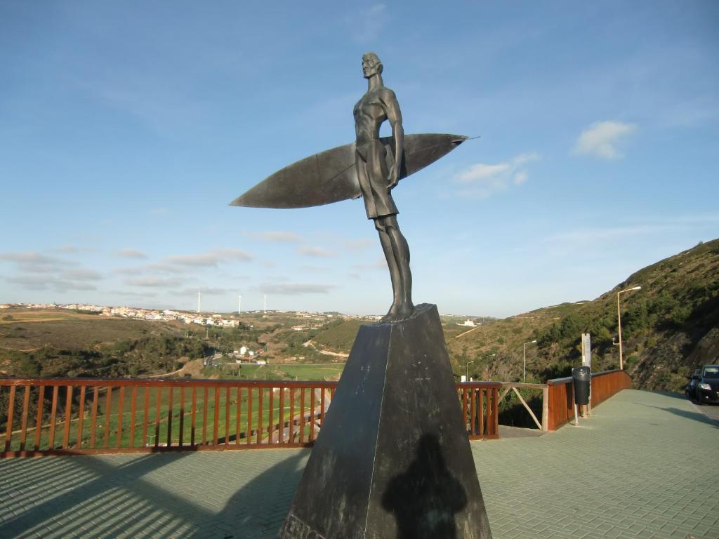a statue of a cross on top of a bridge at The Surf Studio - Ericeira in Ericeira