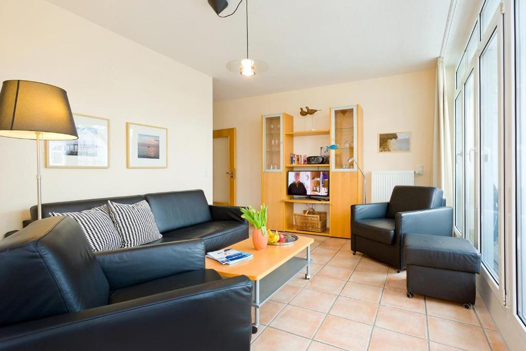 a living room with a couch and a table at Villa Hildegard Appartement 2 in Binz