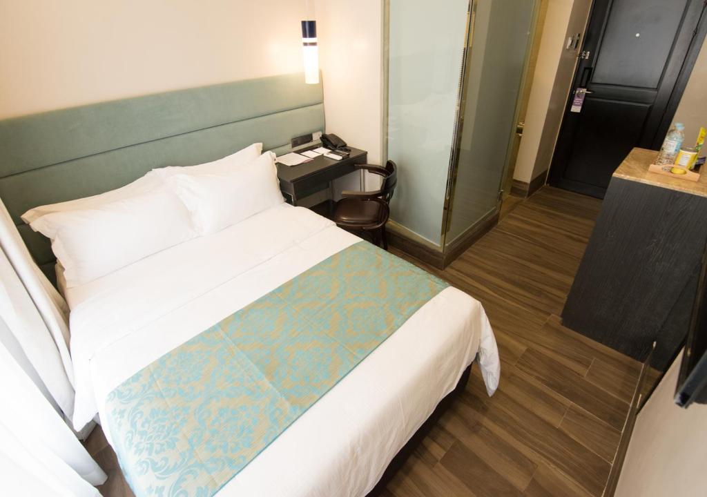 Postel nebo postele na pokoji v ubytování Goldberry Lite Hotel