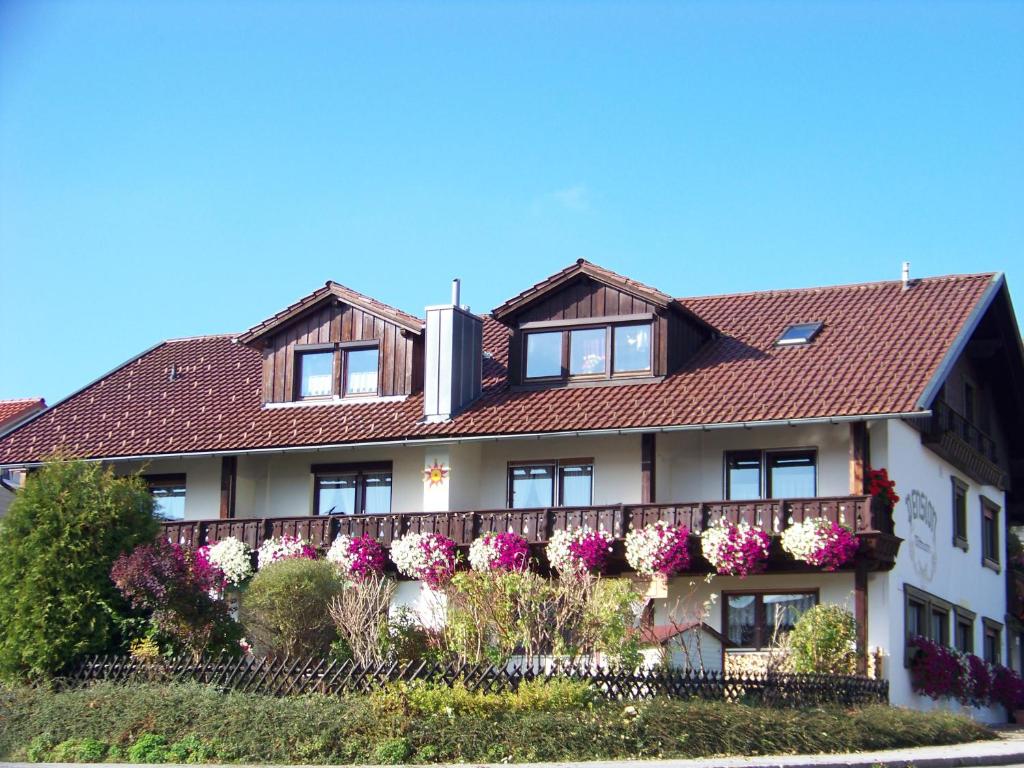 ein Gebäude mit Blumen auf der Seite in der Unterkunft Pension Erna in Zwiesel