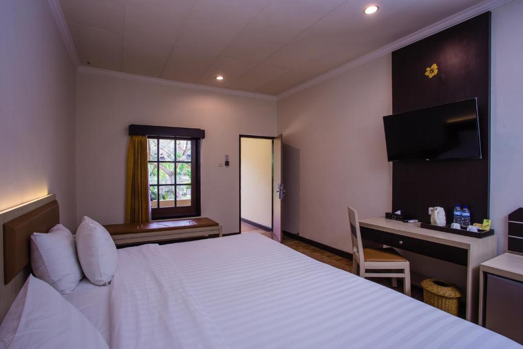 Postel nebo postele na pokoji v ubytování Lombok Garden Hotel