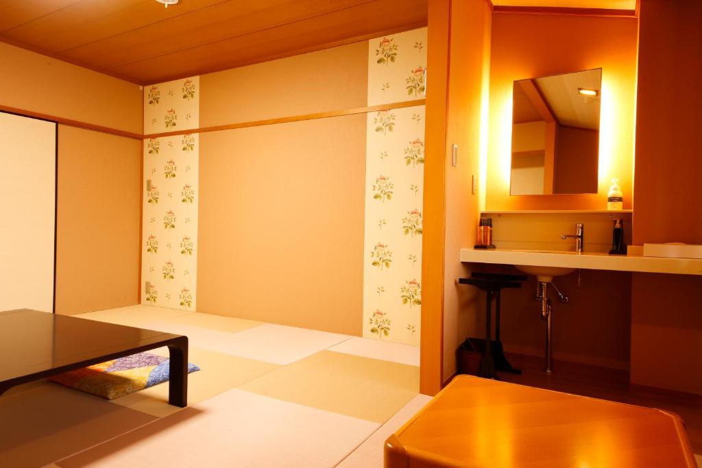 Postel nebo postele na pokoji v ubytování Arima Hot Spring Ryokan Kotori