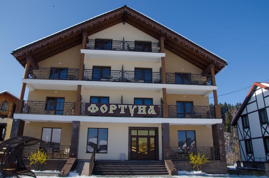 a building with a sign that reads olympia at Fortuna in Skhidnitsa