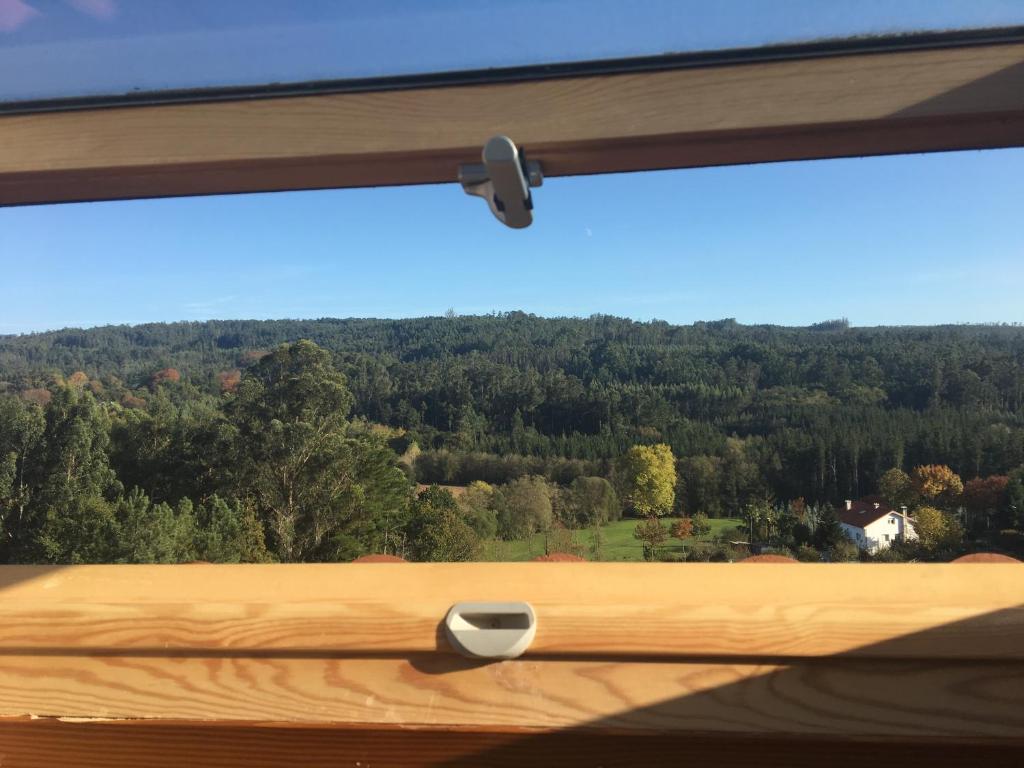 a window with a view of a forest at Pilgrim’s House in O Pedrouzo