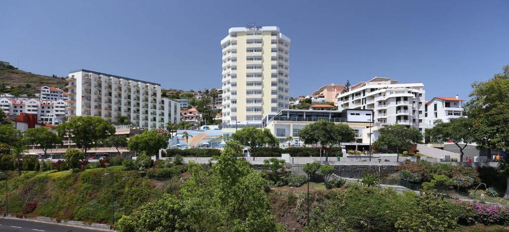 a large city with tall buildings and trees at Muthu Raga Madeira Hotel in Funchal