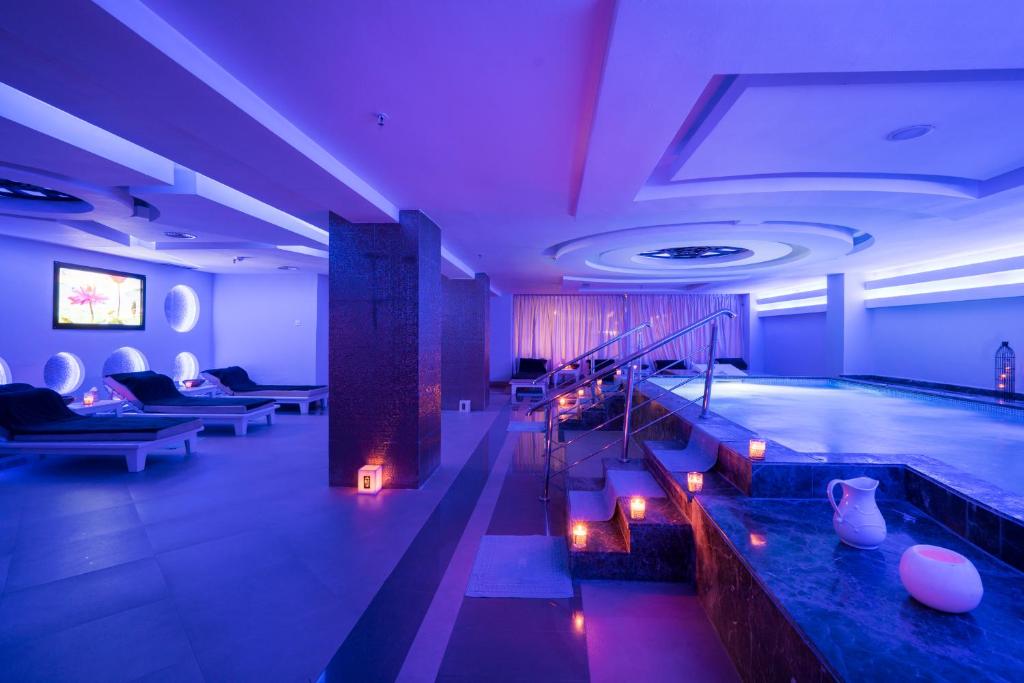 a swimming pool in a large room with a swimming pool at Savoy Le Grand Hotel Marrakech in Marrakesh