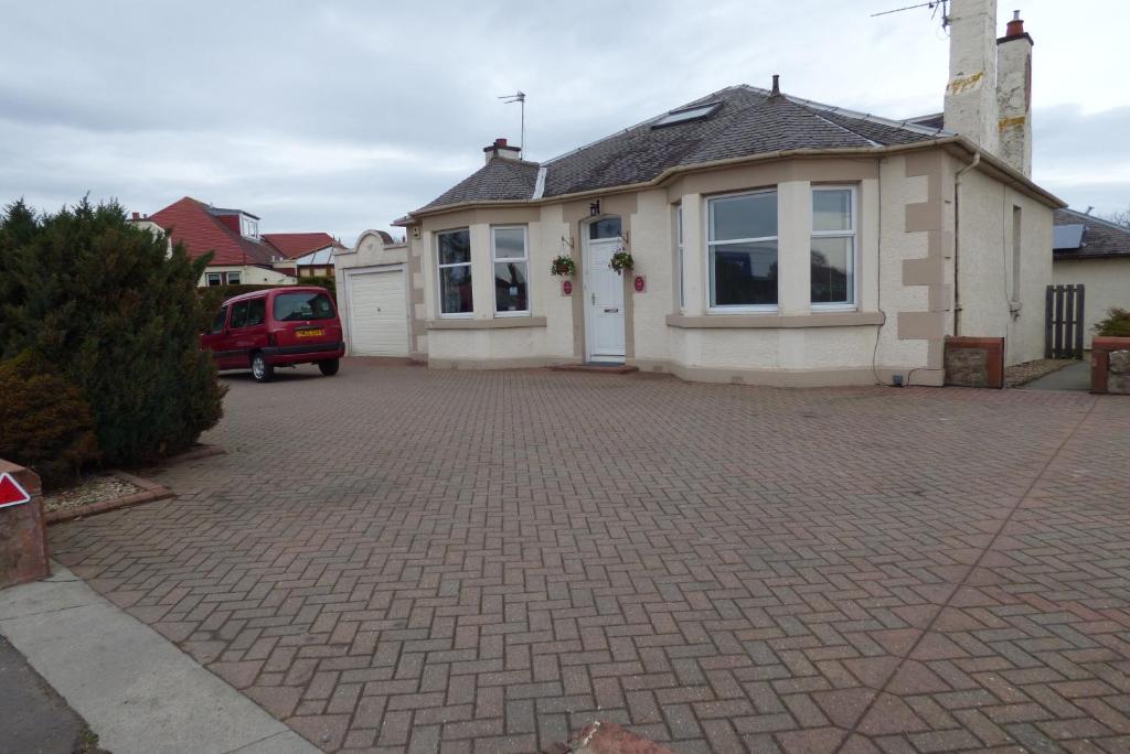 a house with a brick driveway in front of it at Craigievar Guest House in Edinburgh