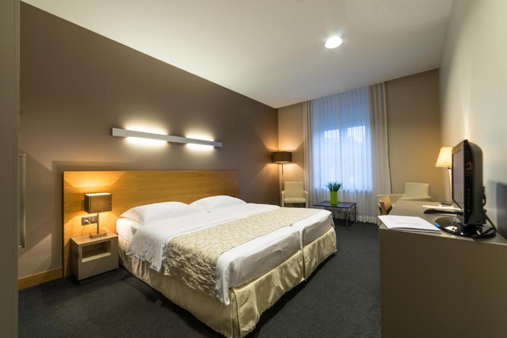 Postel nebo postele na pokoji v ubytování Hotel-Résidence Am Klouschter