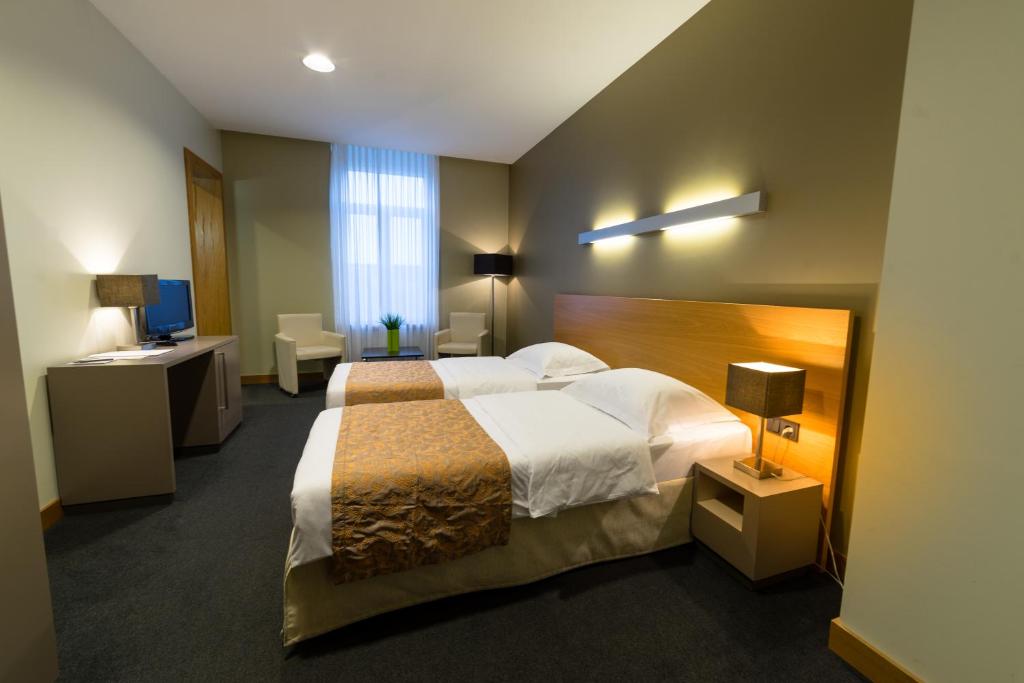 Postel nebo postele na pokoji v ubytování Hotel-Résidence Am Klouschter