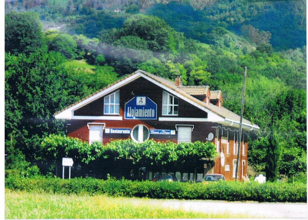 a house with a sign on the side of it at Pension Casa Pepe in Soto de Cangas