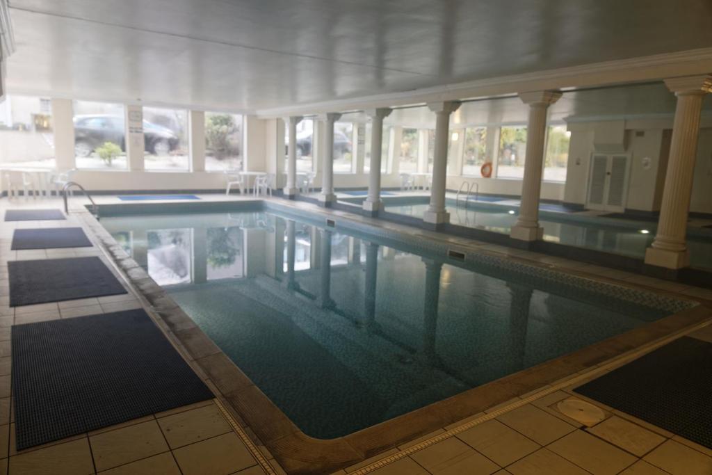 a large swimming pool in a building at 456js Edinburgh Self-Catering Apartment in Edinburgh