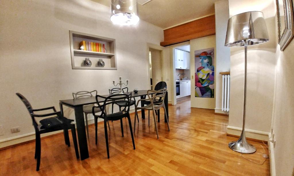 a dining room with a black table and chairs at Domus Orvieto in Orvieto