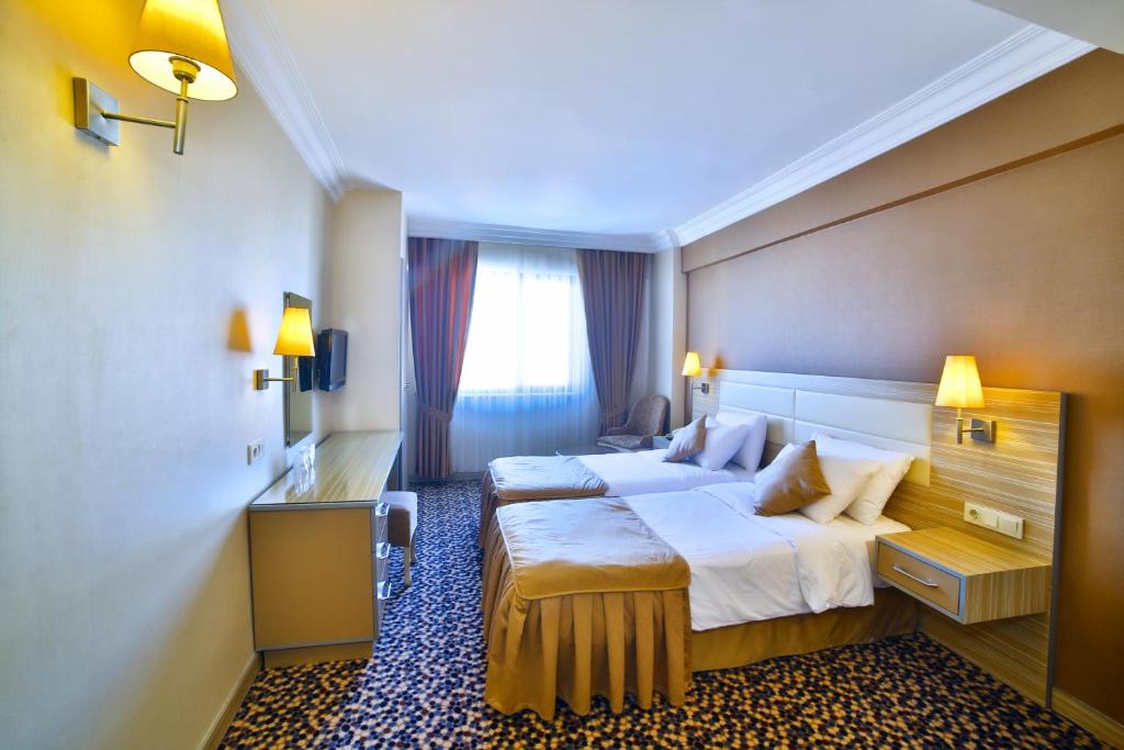 a hotel room with a large bed and a window at Hotel Grand Emin in Istanbul