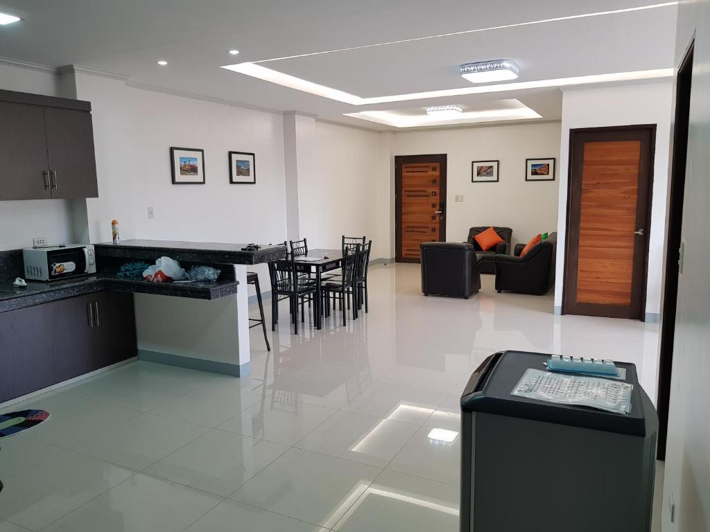 a kitchen and living room with a table and chairs at Entire flat 3rd floor in Lasip Chico