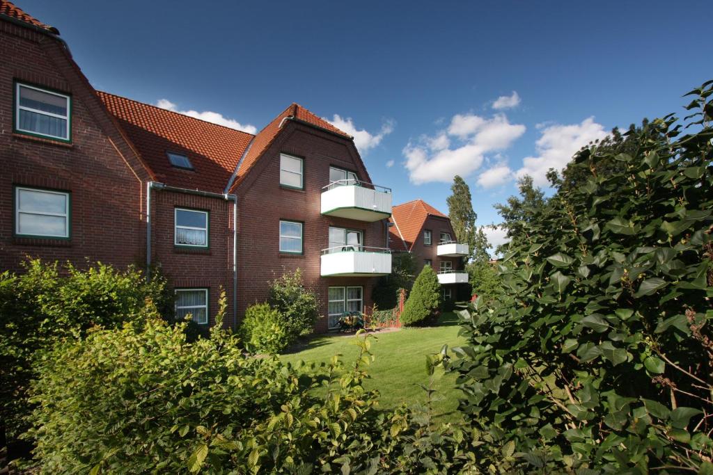 ein Apartmenthaus mit Rasen davor in der Unterkunft Apartmenthaus Holländerei in Büsum