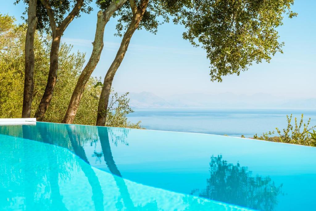 a swimming pool with a view of the ocean at Villa Melolia in Ýpsos