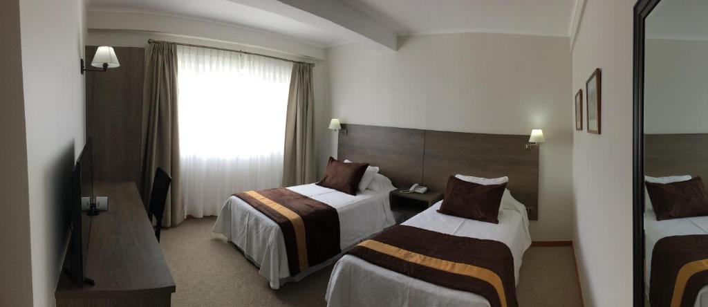 Postel nebo postele na pokoji v ubytování Conrado Hotel Osorno