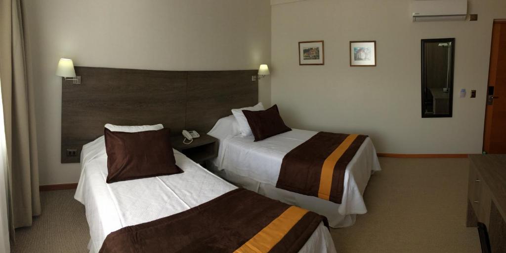 Postel nebo postele na pokoji v ubytování Conrado Hotel Osorno