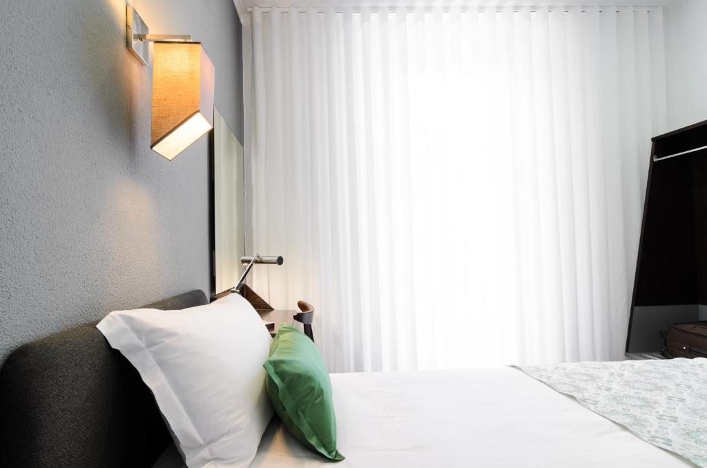 Postel nebo postele na pokoji v ubytování Hotel Portuense Lisboa