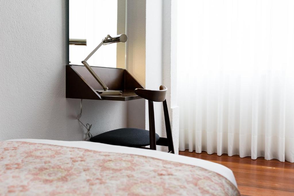 Postel nebo postele na pokoji v ubytování Hotel Portuense Lisboa