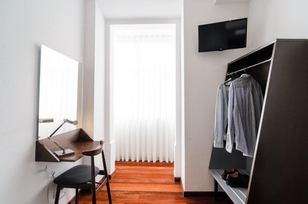 TV a/nebo společenská místnost v ubytování Hotel Portuense Lisboa