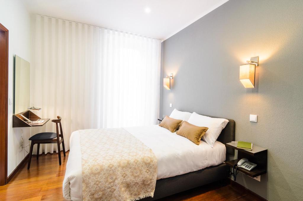 Postel nebo postele na pokoji v ubytování Hotel Portuense Lisboa