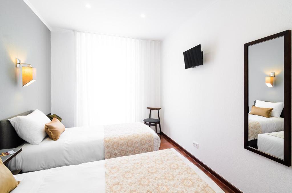 Postel nebo postele na pokoji v ubytování Hotel Portuense Lisboa