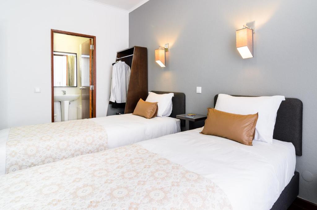 Postel nebo postele na pokoji v ubytování Hotel Portuense Lisboa