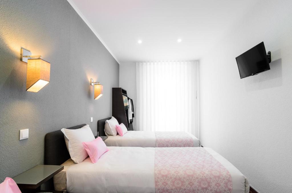 Postel nebo postele na pokoji v ubytování Hotel Portuense Lisboa