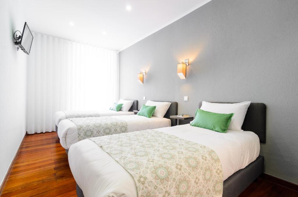 Postel nebo postele na pokoji v ubytování Hotel Portuense Lisboa