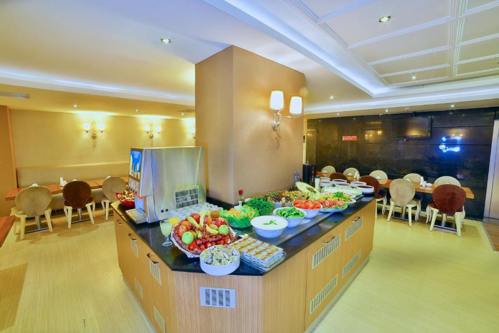 a buffet in a hotel with fruits and vegetables on a counter at Hotel Grand Emin in Istanbul