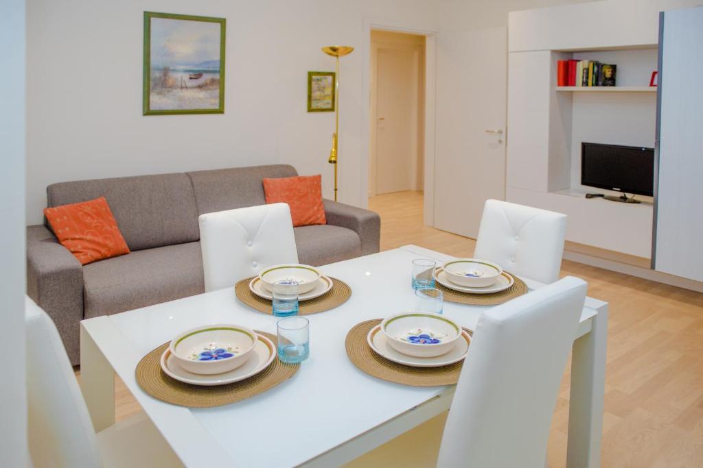 a living room with a white table and chairs and a couch at Niguarda & Bicocca Flat in Milan