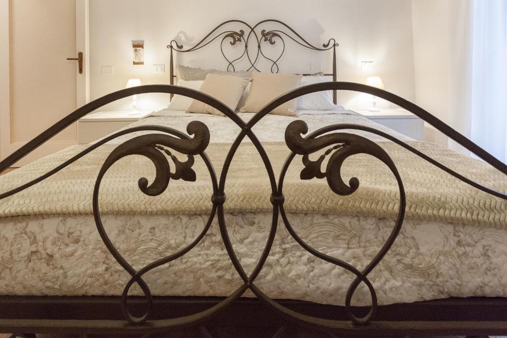 einem Metallbettrahmen in einem Schlafzimmer mit einer weißen Matratze in der Unterkunft Canto XI in Assisi