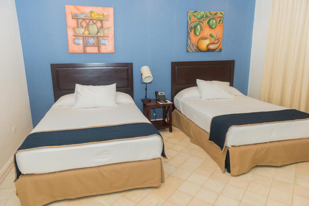 Una cama o camas en una habitación de Hotel Presidente Las Tablas