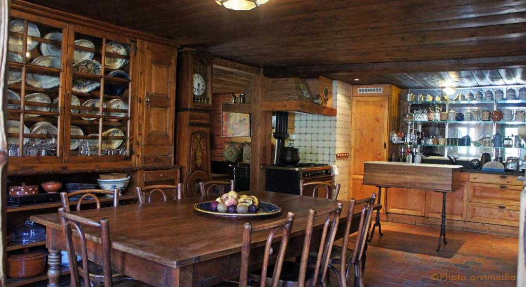 a dining room with a wooden table and chairs at Chalet le 1791 in La Clusaz