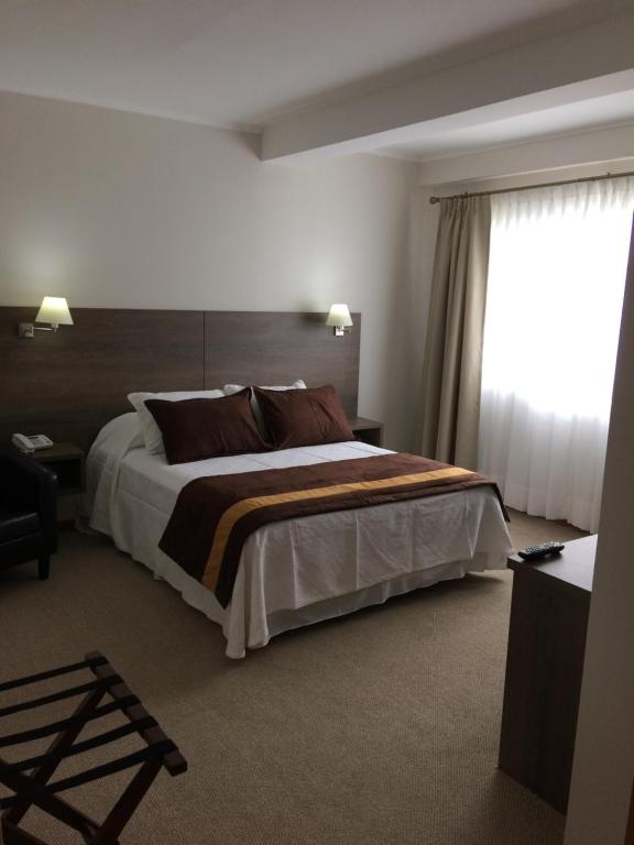 Postel nebo postele na pokoji v ubytování Conrado Hotel Osorno