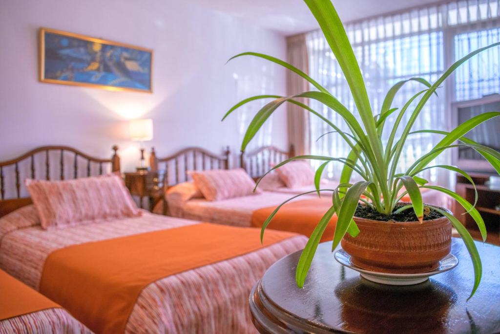 Postel nebo postele na pokoji v ubytování GHL casa hotel