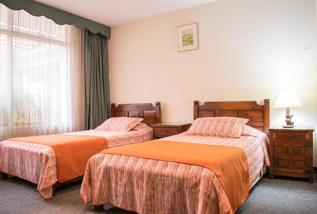 Postel nebo postele na pokoji v ubytování GHL casa hotel