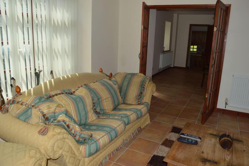sala de estar con sofá y mesa de madera en Stabl yr Nant en Pentrefoelas