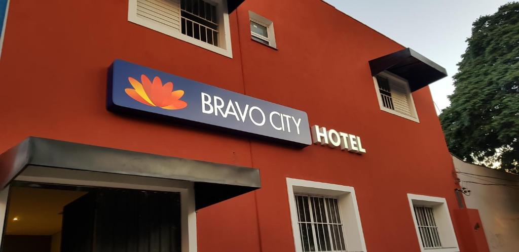 a red building with a berry city hotel sign on it at Bravo City Hotel Campo Grande in Campo Grande