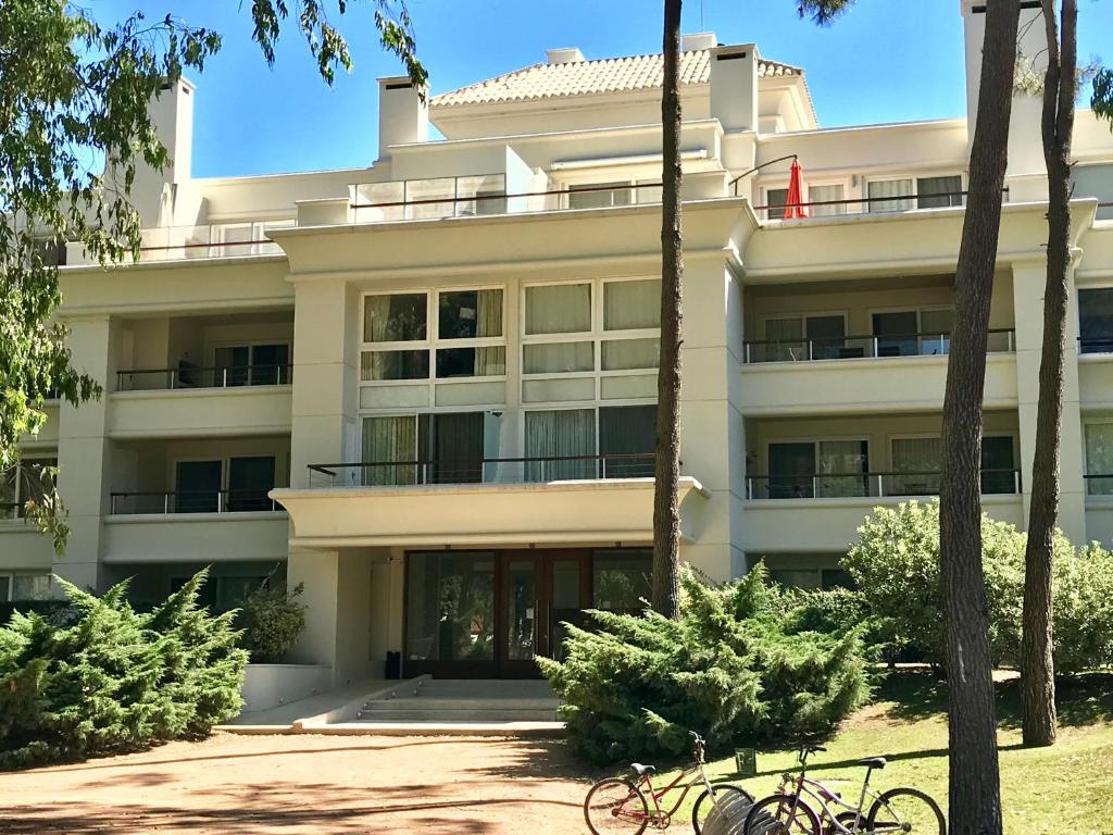 a building with bikes parked in front of it at Departamento Green Park in Punta del Este