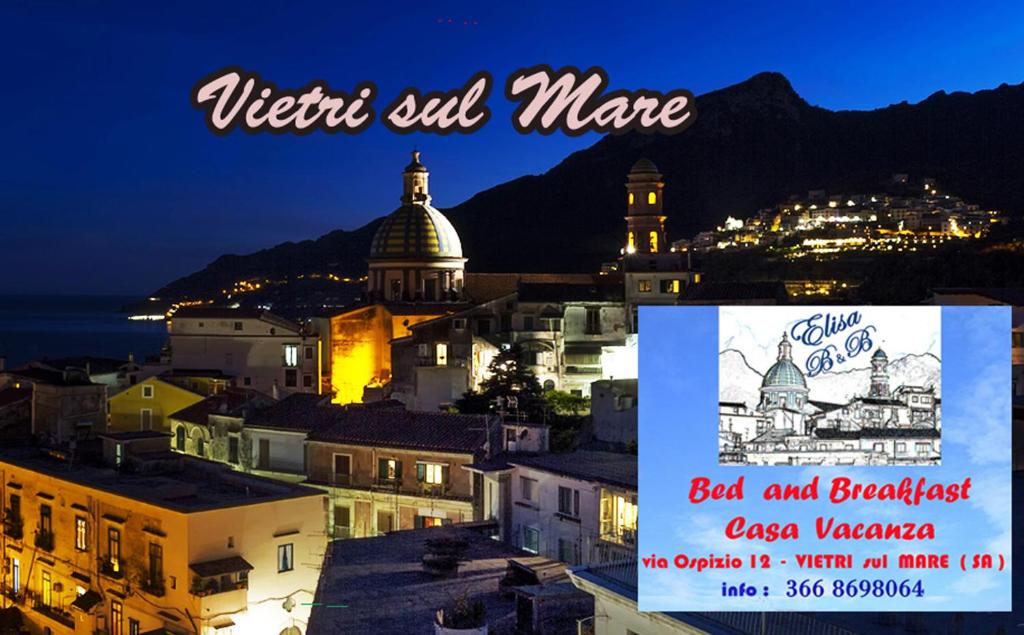 a picture of a city at night with a sign that says vietlez evil at B&B Elisa in Vietri sul Mare