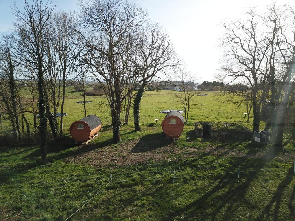 three boats in a field with trees and grass at Les Logis de Kerdrien in Guidel-Plage