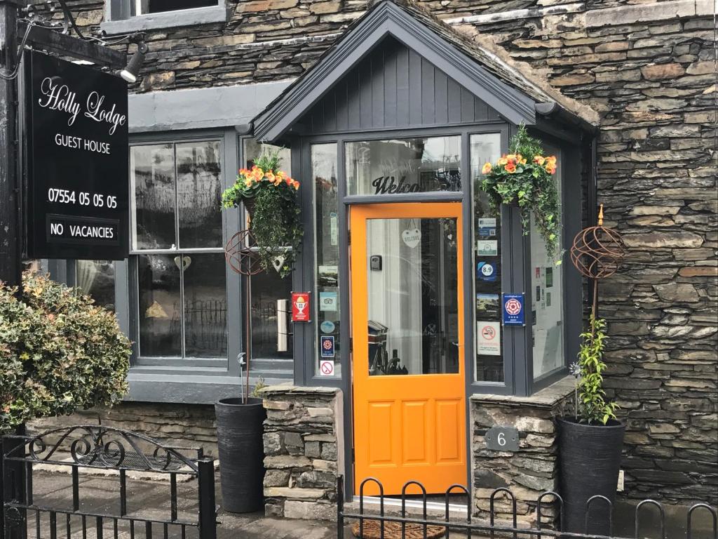 an orange door on the front of a building at Holly Lodge Guest House with FREE off site health club in Windermere