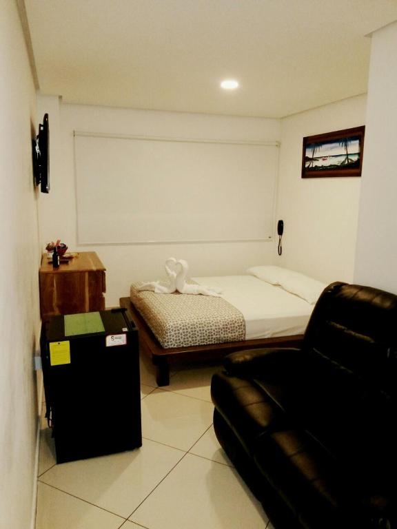 Postel nebo postele na pokoji v ubytování Hotel Bahia Guatape